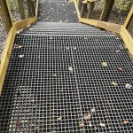 Fiberglass floor grating steps with wire mesh handrail inserts at a national park, similar to products from Direct Metals®.